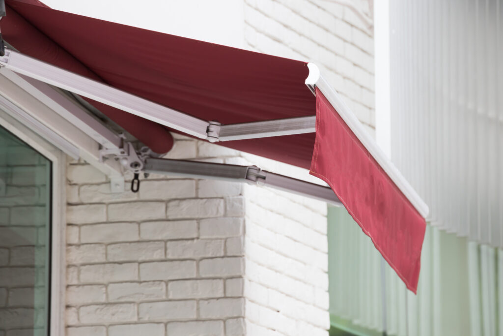 red awning over window of shop.